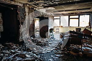 Burnt house interior. Burned room in industrial building, charred furniture and damaged apartment after fire