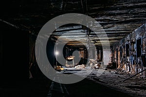 Burnt interior of industrial building basement. Walls in black soot after fire