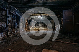 Burnt interior of industrial building basement. Walls in black soot after fire