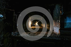 Burnt interior of industrial building basement. Walls in black soot after fire