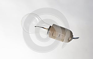 A burnt match in an electric light bulb instead of a spiral in a beige cartridge