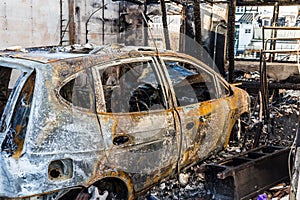 Burnt out car in a garage - police-secured crime scene - forbidden to enter