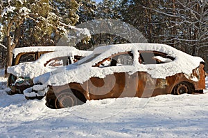 Burnt-out cars covered in snow