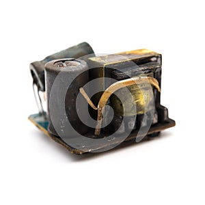Burnt out core of a mobile recharger on white photo