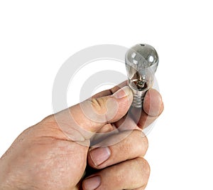 Burnt out light bulb in hand. Isolated a white background
