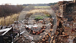 A burnt-out rural house with a brick oven, aerial view.