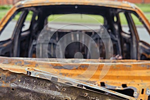 Burnt-out rusty cars on a city street, vandalism. Setting fire to cars by vandals and damage to property