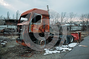 Burnt rusty truck in abandoned industrial area