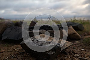 Burnt stones on the beach. Extinguished campfire