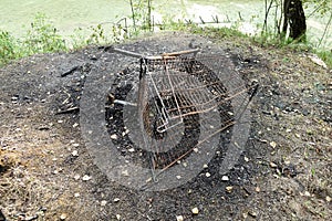 Burnt supermarket cart in ash from a fire. Vandalism