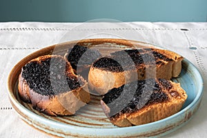 Burnt toast bread on a plate on a white tablecloth