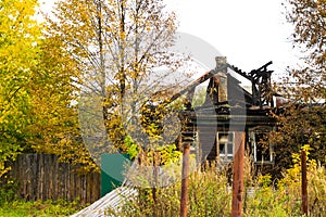 Burnt traditional Russian wooden house izba in autumn