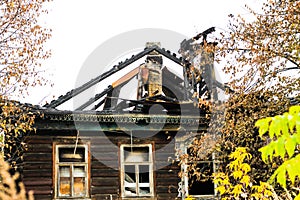 Burnt traditional Russian wooden house izba in autumn photo
