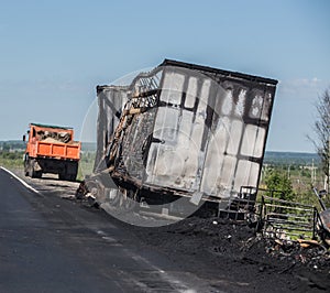 Burnt truck on the side of highway