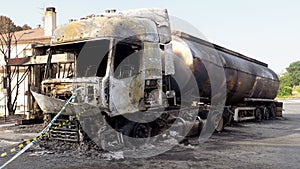 burnt truck with a tanker of gasoline