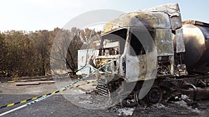 burnt truck with a tanker of gasoline