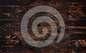 Burnt wooden board, black charcoal wood texture, burned barbecue background