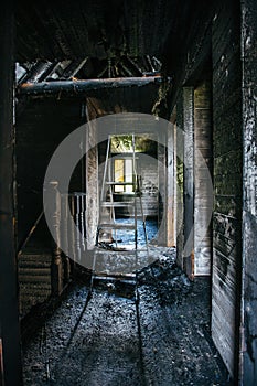 Burnt wooden house interior. Charred walls. Consequences of fire