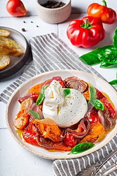 Burrata cheese with baked tomatoes, pepper, red onion and fresh