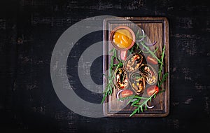 Burritos wraps with beef and vegetables on dark wooden background.