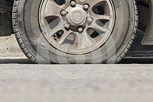 Burst car tire on street.