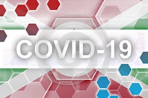 Burundi flag and futuristic digital abstract composition with Covid-19 inscription. Coronavirus outbreak concept