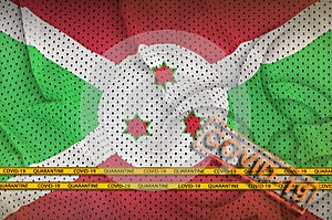 Burundi flag and orange Covid-19 stamp with border tape. Coronavirus or 2019-nCov virus concept