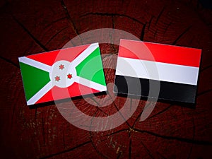 Burundi flag with Yemeni flag on a tree stump