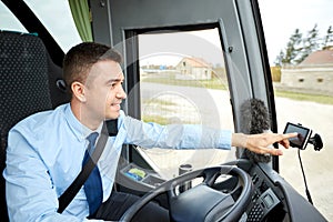 Bus driver entering address to gps navigator