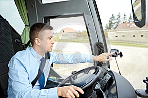 Bus driver entering address to gps navigator