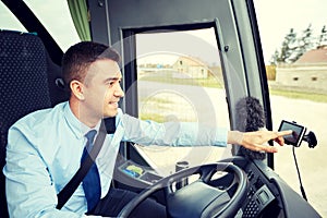 Bus driver entering address to gps navigator