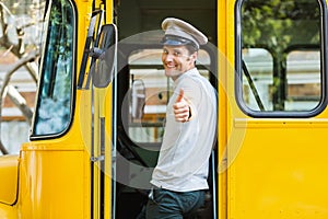 Bus driver showing thumbs up while entering in bus