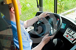 Bus driver sitting in his bus photo