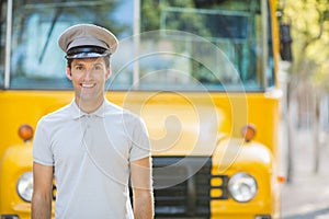 Bus driver smiling in front of bus