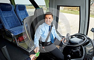 Bus driver taking ticket or card from passenger