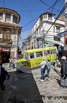 A bus drives down a steep and narrow street in Cerro Cumbre in La Paz in Bolivia.
