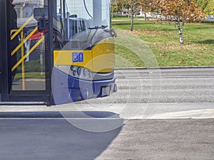 Bus front part on bus stop in the city ready to take passengers