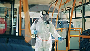 Bus interior is getting chemically sanitized by a specialist