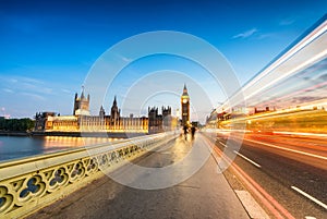 Bus light trails across Wetminster Bridge with blurred moving pe photo