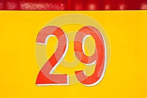 Bus number. Close-up of number 29 aboard a yellow old passenger bus. Retro transport