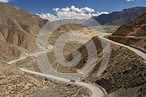 Bus on a road high on the Tibetan Plateau