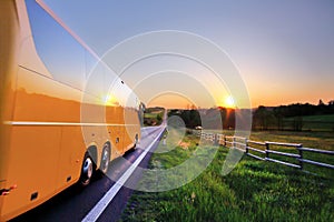 Bus on the road at sunset