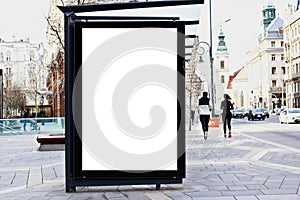 bus shelter with blank white ad billboard at busstop. urban street setting