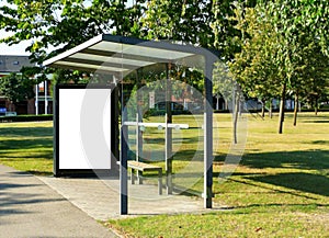 bus shelter with blank white ad panel and light box for mockup at city transit busstop