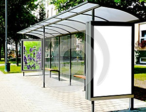 bus shelter with blank white ad panel in lightbox for mockup at city transit busstop