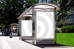 Bus shelter with empty white ad panel and lightbox.