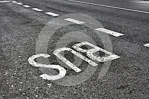 Bus sign on tarmac road photo