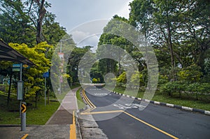 a bus stop in an empty street, near the National University of Singapore