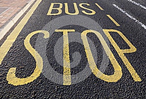 Bus stop sign on asphalt road
