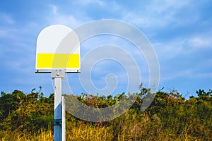 Bus stop sign in the blue sky